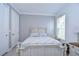 Bright bedroom features a full sized bed, white furniture, and window with blind at 2406 High Tides Way, Wesley Chapel, FL 33543