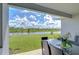 Covered patio with table and chairs overlooking the community pond at 2406 High Tides Way, Wesley Chapel, FL 33543
