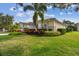 Charming single-story home with well-manicured lawn and colorful landscaping and a red tile roof at 5621 Rock Dove Dr, Sarasota, FL 34241