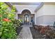 Inviting front entrance featuring double doors, brick walkway, arched entry, and decorative landscaping at 5621 Rock Dove Dr, Sarasota, FL 34241