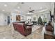Spacious living room with tile flooring, tray ceiling, neutral walls, and ample seating and a piano at 5621 Rock Dove Dr, Sarasota, FL 34241