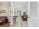 Open-concept living room featuring tile floors, neutral walls, and an archway to a cozy leather sofa at 5621 Rock Dove Dr, Sarasota, FL 34241
