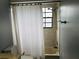 Simple bathroom with shower/tub and white curtain at 10425 La Mirage Ct # 202, Tampa, FL 33615