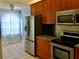 Kitchen with stainless steel appliances and wood cabinets at 10425 La Mirage Ct # 202, Tampa, FL 33615