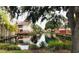 Community waterfront view with lush landscaping and pond at 10425 La Mirage Ct # 202, Tampa, FL 33615