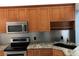 Kitchen with wood cabinets and granite countertops at 10425 La Mirage Ct # 202, Tampa, FL 33615