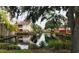 Community features a serene canal with lush landscaping and beautiful homes at 10425 La Mirage Ct # 202, Tampa, FL 33615