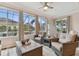 Sunroom with multiple windows, wicker furniture, and pool view at 1119 Villeroy Dr, Sun City Center, FL 33573