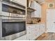 Modern kitchen with built-in wall oven and cooktop at 1119 Villeroy Dr, Sun City Center, FL 33573