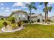 Single-story home with landscaped yard and two-car garage at 1119 Villeroy Dr, Sun City Center, FL 33573
