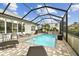 Relaxing screened pool area with patio and lounge chairs at 1119 Villeroy Dr, Sun City Center, FL 33573