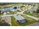 Aerial view of home with private pool and community lake at 1119 Villeroy Dr, Sun City Center, FL 33573