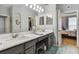 Double vanity bathroom with marble countertop and gray cabinets at 1119 Villeroy Dr, Sun City Center, FL 33573