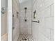 Walk-in shower with tiled walls and grab bars at 1119 Villeroy Dr, Sun City Center, FL 33573