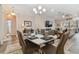 Bright dining room with table set for 6, and views into living areas at 1119 Villeroy Dr, Sun City Center, FL 33573