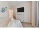 Serene bedroom with TV, dresser, and soft bedding at 1119 Villeroy Dr, Sun City Center, FL 33573