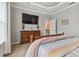 Main bedroom with large TV, dresser, and access to other rooms at 1119 Villeroy Dr, Sun City Center, FL 33573