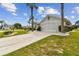 Exterior view of house with screened garage and landscaping at 1119 Villeroy Dr, Sun City Center, FL 33573