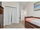 Bedroom with wood bed frame and access to hallway at 1119 Villeroy Dr, Sun City Center, FL 33573