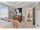 Main bedroom with large TV, dresser, and access to other rooms at 1119 Villeroy Dr, Sun City Center, FL 33573