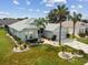 Single-Gathering home with landscaped yard and two palm trees at 1119 Villeroy Dr, Sun City Center, FL 33573