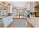 Modern kitchen with white cabinets, granite counters, and island at 1119 Villeroy Dr, Sun City Center, FL 33573