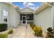 Front porch with red door and small seating area at 1119 Villeroy Dr, Sun City Center, FL 33573