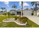 Single story house with landscaped yard and palm trees at 1119 Villeroy Dr, Sun City Center, FL 33573
