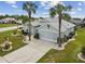 Single-Gathering home with landscaped yard and two palm trees at 1119 Villeroy Dr, Sun City Center, FL 33573