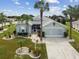 Single-Gathering home with landscaped yard and two palm trees at 1119 Villeroy Dr, Sun City Center, FL 33573