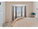 Bright bedroom with bay window, plush bedding, and ample natural light at 1119 Villeroy Dr, Sun City Center, FL 33573