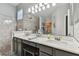 Double vanity bathroom with marble countertop and gray cabinets at 1119 Villeroy Dr, Sun City Center, FL 33573