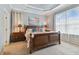 Spacious main bedroom with wooden bed frame and ocean-themed decor at 1119 Villeroy Dr, Sun City Center, FL 33573