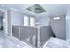 Elegant staircase with an ornate railing and chandelier at 2406 High Tides Way, Wesley Chapel, FL 33543