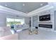 Spacious living room with a fireplace and sliding glass doors at 2406 High Tides Way, Wesley Chapel, FL 33543