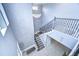 Impressive staircase with wrought iron railing and geometric wall detail at 2406 High Tides Way, Wesley Chapel, FL 33543