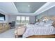 Main bedroom with large bed, sitting area, and a dresser at 2406 High Tides Way, Wesley Chapel, FL 33543