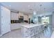 Modern kitchen with white cabinets, an island, and stainless steel appliances at 2406 High Tides Way, Wesley Chapel, FL 33543