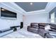 Game room with large TV, leather sectional sofa, and entertainment center at 2406 High Tides Way, Wesley Chapel, FL 33543