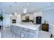 Modern kitchen with white cabinets, large island, and stainless steel appliances at 2406 High Tides Way, Wesley Chapel, FL 33543