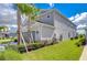 Side view of the house, showcasing landscaping and garage at 2406 High Tides Way, Wesley Chapel, FL 33543