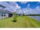 Backyard of home with pond view and grassy area at 2406 High Tides Way, Wesley Chapel, FL 33543