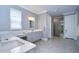Elegant bathroom with double vanity, large shower, and grey tile floors at 2406 High Tides Way, Wesley Chapel, FL 33543