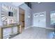 Bright foyer with double doors, geometric wall, and tiled floors at 2406 High Tides Way, Wesley Chapel, FL 33543