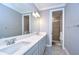 Double vanity bathroom with a large mirror and shower at 2406 High Tides Way, Wesley Chapel, FL 33543