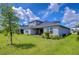 House exterior view showing gray siding and backyard at 2406 High Tides Way, Wesley Chapel, FL 33543