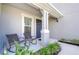 Cozy front porch with rocking chairs and lush landscaping at 2406 High Tides Way, Wesley Chapel, FL 33543