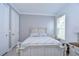 Light and airy bedroom with a white dresser and wood-framed bed at 2406 High Tides Way, Wesley Chapel, FL 33543