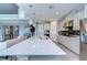 Modern kitchen with white cabinets, large island, and stainless steel appliances at 2406 High Tides Way, Wesley Chapel, FL 33543
