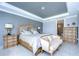Main bedroom with large bed, sitting area, and a dresser at 2406 High Tides Way, Wesley Chapel, FL 33543